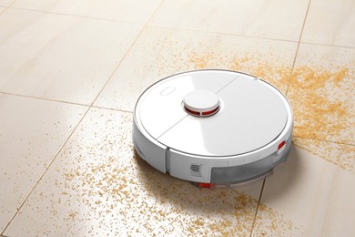 Robot vacuum cleaner removing dirt from floor in room