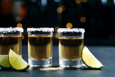 Mexican Tequila shots, lime slices and salt on bar counter