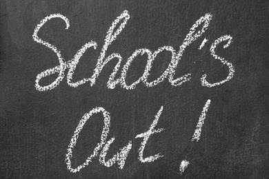 Text School's Out written on black chalkboard. Summer holidays