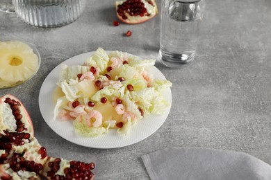 Photo of Delicious salad with Chinese cabbage, shrimps and pineapple served on grey table, space for text