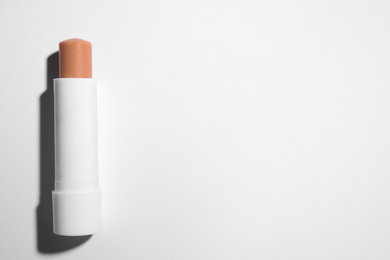 Hygienic lipstick on white background, top view