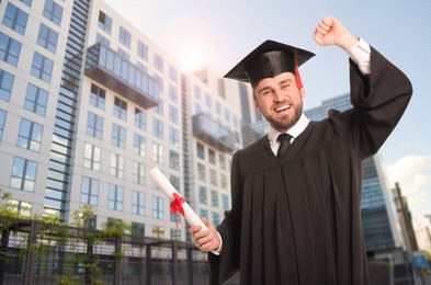 Happy student with graduation hat and diploma outdoors
