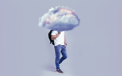 Man with cloud on his head against grey background. Modern storage technology concept