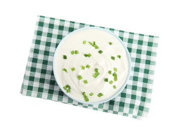 Fresh sour cream with onion and fabric on white background, top view