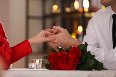Couple having romantic dinner on Valentine's day in restaurant, closeup
