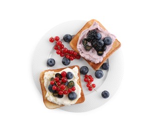 Photo of Tasty sandwiches with cream cheese, blueberries, red currants and blackberries on white background, top view