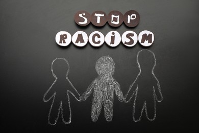 Phrase Stop Racism near white and black people drawn on blackboard, flat lay