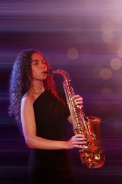 Beautiful African American woman playing saxophone on dark background. Bokeh effect