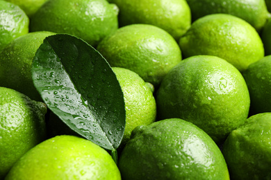 Fresh ripe juicy limes as background, closeup