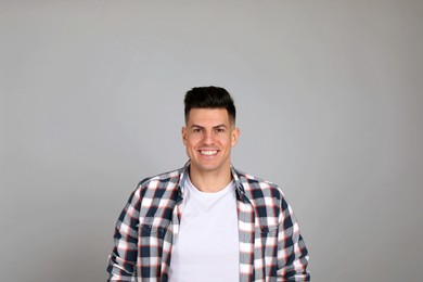 Portrait of happy man on light grey background. Personality concept