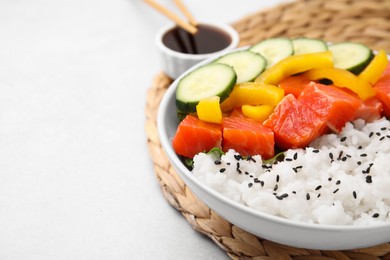 Photo of Delicious poke bowl with salmon, rice and vegetables on white table, closeup. Space for text