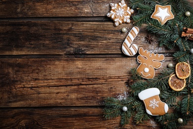 Flat lay composition with tasty Christmas cookies on wooden table, space for text