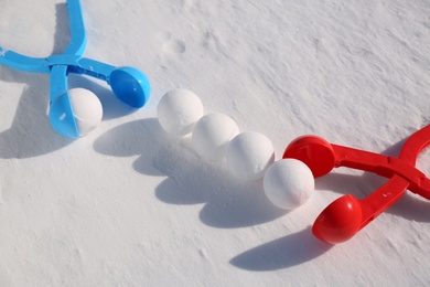 Snowballs and plastic tools outdoors on winter day