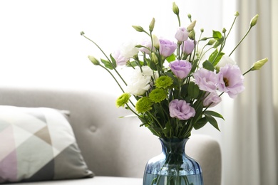 Bouquet of beautiful Eustoma flowers in room, closeup. Space for text