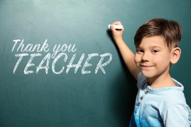 Cute little boy written phrase Thank You Teacher on green chalkboard