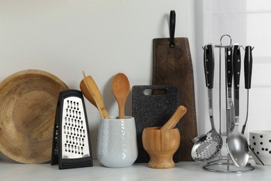 Different cooking utensils on countertop in kitchen