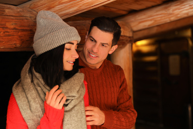 Lovely couple wearing warm sweaters indoors. Winter season