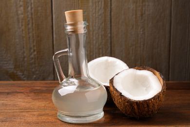 Coconut oil in glass jug on wooden table