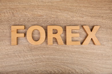 Photo of Word Forex made with letters on wooden table, flat lay