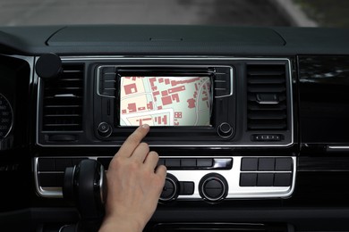 Image of Woman using navigation system while driving car, closeup