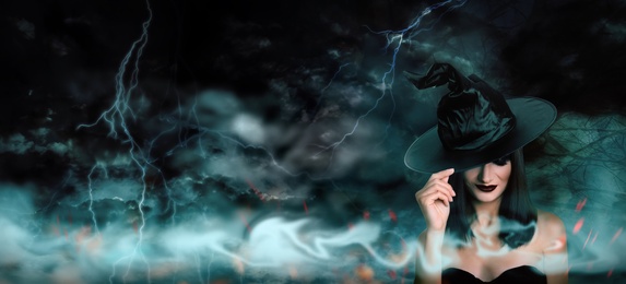 Young girl dressed as witch in misty forest on stormy night. Halloween fantasy