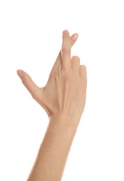 Woman with crossed fingers on white background, closeup. Superstition concept