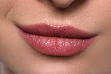 Photo of Young woman with beautiful plump lips, closeup