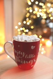 Hot drink with marshmallows in room. Magic Christmas atmosphere