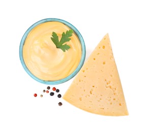 Tasty cheese, sauce with parsley and peppercorns on white background, top view