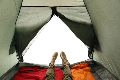 Closeup of female in camping tent on white background, view from inside