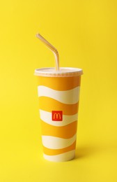 MYKOLAIV, UKRAINE - AUGUST 12, 2021: Cold McDonald's drink on yellow background