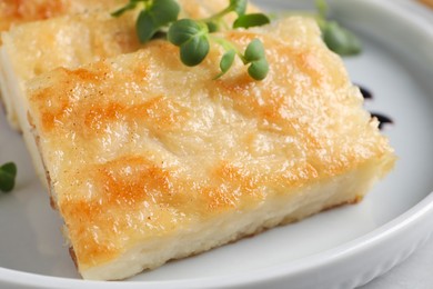 Delicious turnip cake with microgreens on table, closeup