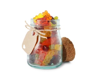 Delicious gummy bear candies in glass jar on white background