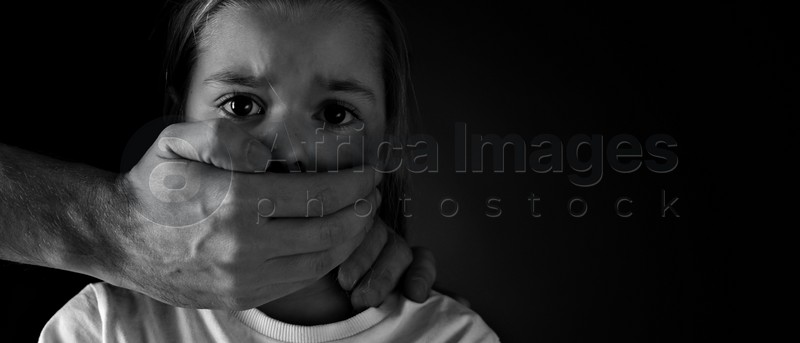 Image of Man covering scared little girl's mouth on black background, space for text. Domestic violence. Banner design
