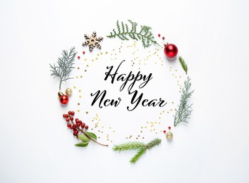 Happy New Year! Flat lay composition with fit tree branches and festive decor on white background 