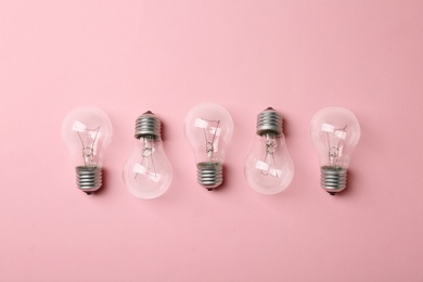 New incandescent lamp bulbs on pink background, top view