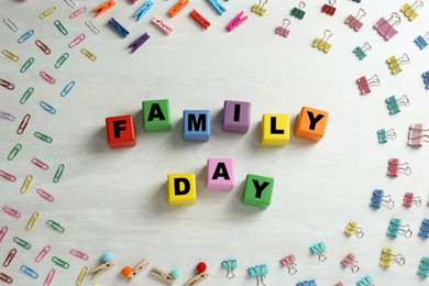 International Family day. Flat lay composition with cubes, binder clips and clothespins on white wooden background