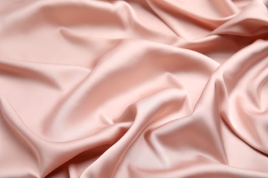 Texture of delicate pink silk as background, closeup