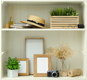 White shelving unit with different decorative elements