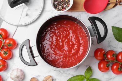 Delicious tomato sauce on white marble table, flat lay