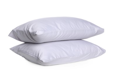 New soft bed pillows on white background. Silky linens