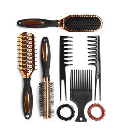 Set of modern hair combs and brushes and spiral rubber bands isolated on white, top view