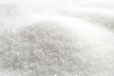 Photo of Pile of granulated sugar as background, closeup