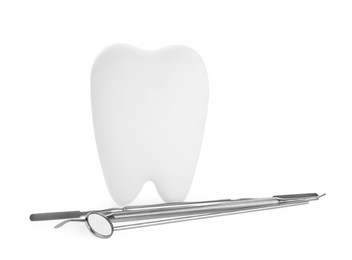 Tooth shaped holder and dental tools on white background