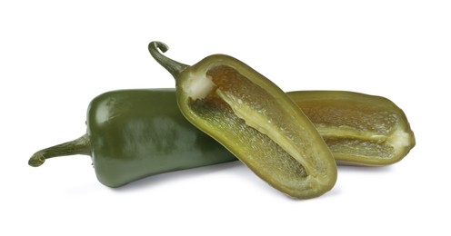 Photo of Whole and cut pickled green jalapenos on white background
