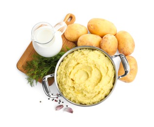 Pot of tasty mashed potatoes near ingredients on white background, top view
