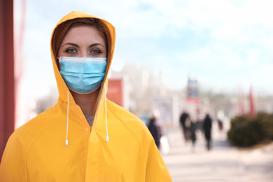 Woman with medical mask on city street. Virus protection