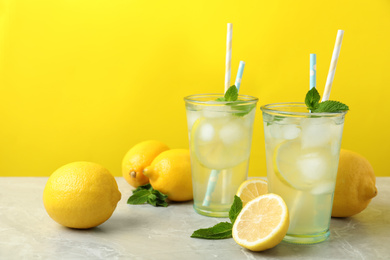 Natural freshly made lemonade on light grey marble table. Summer refreshing drink