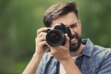 Professional photographer with camera on blurred background