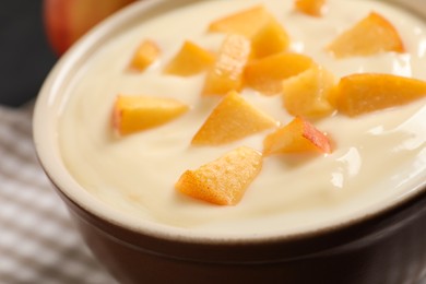 Delicious yogurt with fresh peach in bowl, closeup